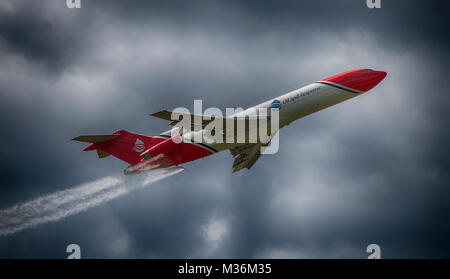 Oil Spill Response Boeing 727 flying demo with spray system operating, Farnborough International Airshow 2016. Stock Photo