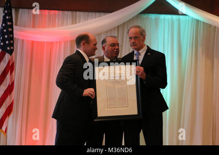Senators Tom Carper and Chris Coons present Maj. Gen. (retired) Frank Vavala with the Congressional Record at the Delaware National Guard Annual Prayer Breakfast on Tuesday, February 28, 2016, in honor of his nearly 50 years of service to the Delaware National Guard, 18 of those as the Adjutant General.  (U.S. Army National Guard photo by 2nd Lt. Wendy Callaway) DNG Prayer Breakfast by Delaware National Guard Stock Photo