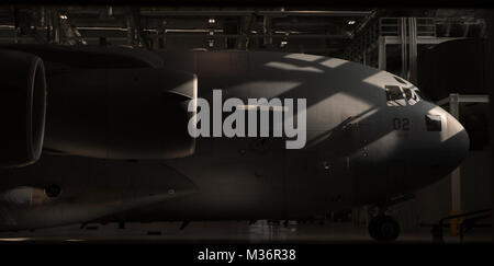 A C-17 Globemaster III sits in a Hanger on Pápa Air Base, Hungary, March 25. The Strategic Airlift Capability program, a multinational mission, is comprised of 12 countries operating out of Pápa Air Base. The international unit is called the Heavy Airlift Wing, and is the first non-NATO unit of its kind. (U.S. Air Force Photo/Master Sgt. Brian Ferguson) 170325-F-BP133-205.jpg by AirmanMagazine Stock Photo