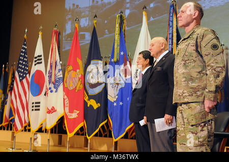 Lt. Gen. Stephen Lanza, I Corps commanding general, retired Maj. Gen. John Hemphill and Consul General Duk-ho Moon, Republic of Korea, stand at attention as the honors to the Korean-era veterans are performed by Battery A, 1-37th FA, 7th Infantry Division during the Korean-era Veterans' Salute at Joint Base Lewis-McChord, Wash., Nov. 13. US Army Recognizes Korean War Veterans at Joint Base Lewis-McChord by #PACOM Stock Photo