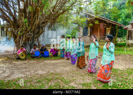 Krabi, Thailand - May 3, 2015: Senior women doing Ronggeng dance while senior men playing music in Lanta island of Krabi, Thailand Stock Photo