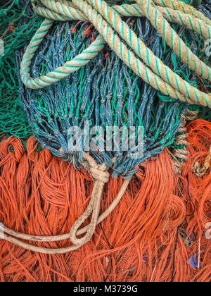 Multi-colored fishing nets drying in the sun next to small fishing boat on  Nilaveli beach in Trincomalee Sri Lanka Asia Stock Photo - Alamy
