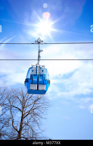 blue elevator ski cabin against blue sky Stock Photo