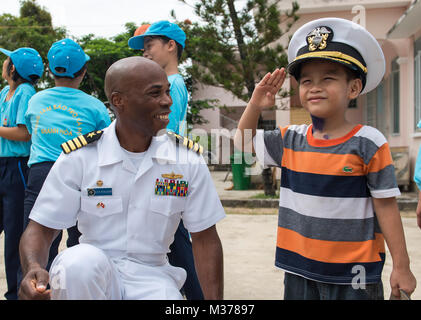 170706-N-OU129-053 NHA TRANG, Vietnam (July 6, 2017) Capt. Lex Walker, commodore, Destroyer Squadron 7, interacts with a resident of Khanh Hoa Center for Social Protection during Naval Engagement Activity (NEA) Vietnam 2017 July 6. The engagement provides an opportunity for Sailors from the U.S. and Vietnam People's Navy to interact and share knowledge to enhance mutual capabilities and strengthen solid partnerships with the local community. (U.S. Navy photo by Mass Communication Specialist 2nd Class Joshua Fulton/Released) Naval Engagement Activity Vietnam 2017 provides opportunity for commun Stock Photo