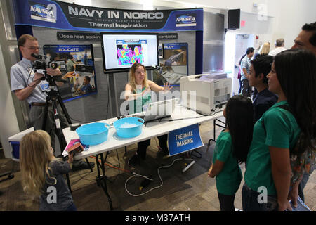 161105-N-HW977-115 NORCO, Calif. (Nov. 5, 2016) Kevin Janosky, left, and Amanda Lynch make a thermal imaging portrait of a family with a forward-looking infrared (FLIR) camera during the Open House Science Experience at Naval Surface Warfare Center (NSWC), Corona Division. The event included numerous hands-on exhibits of Navy-relevant science, technology, engineering and math for local K-12 students, as well as laboratory tours and historic displays showcasing the command's 75-year presence in the Inland Empire. (U.S. Navy photo by Greg Vojtko/Released) 161105-N-HW977-115 by NAVSEA Corona Stock Photo