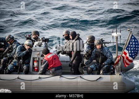 161117-N-UF697-074  SEA OF JAPAN (Nov. 17, 2016) Sailors assigned to the forward-deployed Arleigh Burke-class guided-missile destroyer USS Barry (DDG 52) visit, board, search and seizure (VBSS) team approach the ship in a rigid-hull inflatable boat (RHIB) during a training exercise. Barry is on patrol in the U.S. 7th Fleet area of operations supporting security and stability in the Indo-Asia-Pacific region. (U.S. Navy photo by Petty Officer 2nd Class Kevin V. Cunningham/Released) USS Barry trains for Visit, Board, Search and Seizure operations by #PACOM Stock Photo