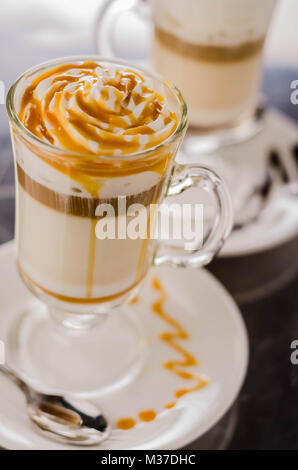 glass of caramel latte Steam milk on a blur background Stock Photo