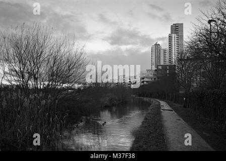 The New River path in winter at Woodberry Down, North London UK, with new apartments in background Stock Photo