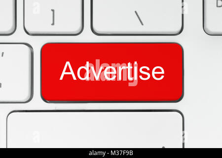 Red button with adverise word on the keyboard close-up Stock Photo
