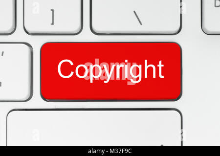 Red button with copyright word on the keyboard close-up Stock Photo