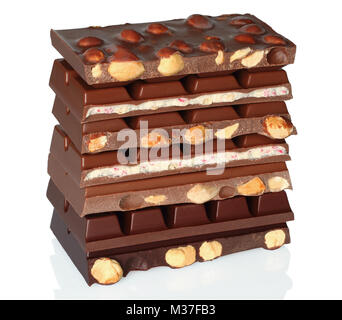 Broken chocolate bars with nuts on white background Stock Photo