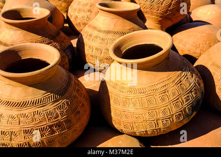 Pottery is made and drying in the sun at the outskirts of the city near the Irrawaddy River Stock Photo