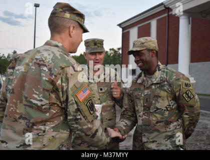 BRUNSWICK, Ga. Sept. 12, 2017 – Major General Joe Jarrard, Georgia’s Adjutant General and Lt. Col. James Collie, commander of the 170th Military Police Battalion, thank 1st Lt. Edner Julien, executive officer of the 179th Military Police Company for his unit’s efforts in Glynn County. While Julien lives in California, he continues to drill with the Georgia Guard because, in his words, “I Love what I do.” Georgia National Guard photo by Capt. William Carraway / released California Resident, Ga. Guardsman by Georgia National Guard Stock Photo