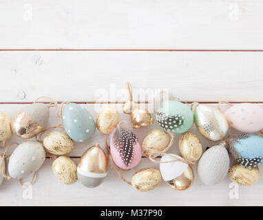 Colorful easter decorations with easter eggs and golden bunny Stock Photo