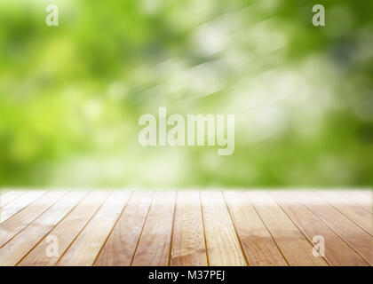 Empty wooden table with blurred defocused trees in park outdoors background - Space for text Stock Photo
