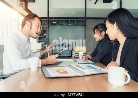 Asian businessman present sell graph at meeting room in office. Business present and meeting concept. Stock Photo