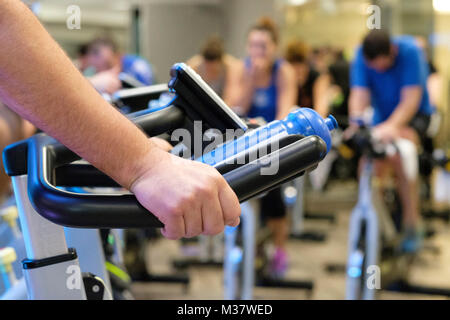 Close up of person during a spinning class at the gym Stock Photo