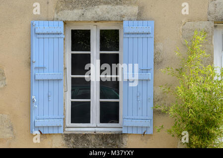 Window with blue wooden shutters in Labastide-d'Armagnac, Landes Department, Nouvelle-Aquitaine, Southwest France Stock Photo