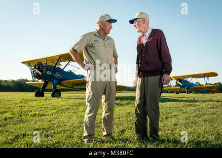 Al Tucker Jr., 96,  and First Sgt. Dave Brown, U.S. Air Force Reserve, talk after Tucker took off, flew and landed Brown's PT-17 Stearman biplane multiple times at the Flying Circus Aerodrome in Bealeton, Va., Jul. 30, 2017. Brown's PT-17 is the same model in which Tucker trained at West Point in 1942 before going on to fly P-38 fighter aircraft over Europe with the U.S. Army Air Corps 434th Fighter Squadron during WWII with his friend, then Lt., Robin Olds. The two have been flying together for nearly 10 years. (U.S. Air Force photo by J.M. Eddins Jr.) 20170730-F-LW859-028 by AirmanMagazine Stock Photo