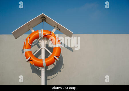 Orange lifebuoy on the pier Stock Photo