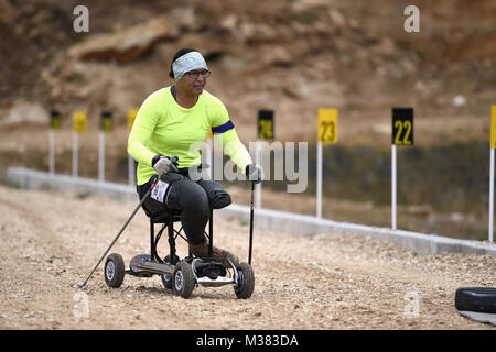 Former Marine Pfc. Jataya Taylor, from Aurora, Colorado, eyes her shooting position after the first lap of the culminating time trial event at the Adaptive Biathlon Camp, Sept. 28 at the Casper Mountain Biathlon Club. She lost her leg following a training exercise. This is the ninth year, the club has helped train wounded veterans and her first time trying the sport. (Wyoming Army National Guard photo by Sgt. 1st Class Jimmy McGuire) 170928-Z-CG686-0004 by wyoguard Stock Photo