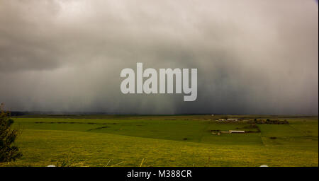 Beachy Head, East Sussex, UK. 8th February 2018. A snow and hail storm passes across the South Downs at Beachy Head before continuing out to sea. Stock Photo