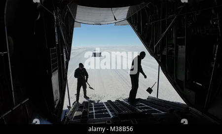 Master Sgt. Randy Powell and Airman 1st Class Jason Vannostrand, loadmasters with the 139th Airlift Squadron, level an LC-130 Hercules aircraft ramp in deep snow at Raven Camp, Greenland, July 30, 2017. Raven Camp is used to train aircrews on LC-130 operations on snow runways. (U.S. Air Force photo by Tech. Sgt. Greg C. Biondo/Released) 170728-F-FA171-065 by AirmanMagazine Stock Photo
