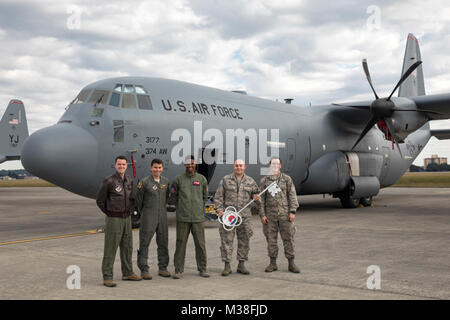 Members of the C-130J delivery team pose for a photo in front of a C-130J Super Hercules at Yokota Air Base, Japan, Oct. 31, 2107. This is the sixth C-130J delivered to Yokota and the first from Dyess Air Force Base, Texas, as part of fleet-wide redistribution of assets set in motion by Air Mobility Command. (U.S. Air Force photo by Yasuo Osakabe) One more C-130J is delivered to Yokota Air Base as part of a fleet-wide distribution of assets by #PACOM Stock Photo
