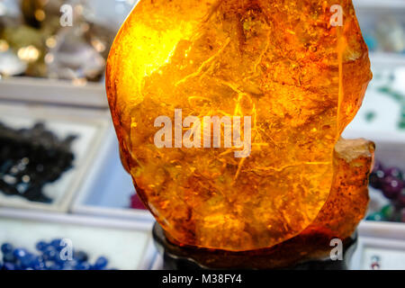 A big amber with an enclosed scorpion is for sale in the jade market Stock Photo