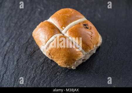 Hot cross bun n a grey slate platter Stock Photo