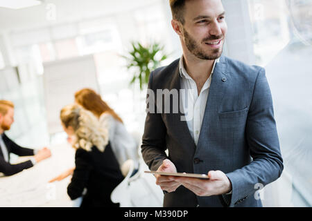 Handsome businessman using tablet pc in office Stock Photo
