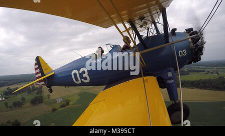 Al Tucker Jr., 96, takes the controls from the front cockpit of the PT-17 Stearman biplane owned by First Sgt. Dave Brown, U.S. Air Force Reserve, at the Flying Circus Aerodrome in Bealeton, Va., Jul. 30, 2017. Brown's PT-17 is the same model in which Tucker trained at West Point in 1942 before going on to fly P-38 fighter aircraft over Europe with the U.S. Army Air Corps 434th Fighter Squadron during WWII with his friend, then Lt., Robin Olds. The two have been flying together for nearly 10 years. (U.S. Air Force photo by Pete Ising) Al and Dave Flying00063 by AirmanMagazine Stock Photo