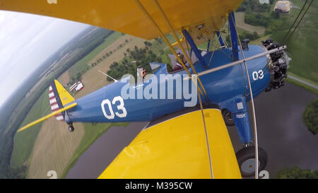 Al Tucker Jr., 96, takes the controls from the front cockpit of the PT-17 Stearman biplane owned by First Sgt. Dave Brown, U.S. Air Force Reserve, at the Flying Circus Aerodrome in Bealeton, Va., Jul. 30, 2017. Brown's PT-17 is the same model in which Tucker trained at West Point in 1942 before going on to fly P-38 fighter aircraft over Europe with the U.S. Army Air Corps 434th Fighter Squadron during WWII with his friend, then Lt., Robin Olds. The two have been flying together for nearly 10 years. (U.S. Air Force photo by Pete Ising) Flying DaveAnd AL020 by AirmanMagazine Stock Photo