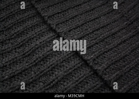 Black ribbed woolen textile edges diagonal line abstract background Stock Photo