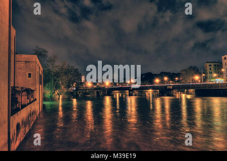 Extraordinary full of the Tiber river at night from the Tiber island to palatine bridge, swallen river. Rome, Italy Stock Photo