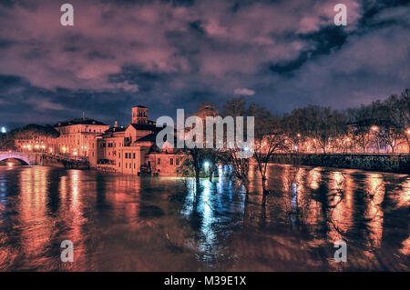 Extraordinary full of the Tiber river at night at the Tiber island (Isola Tiberina) from palatine bridge, swallen river. Rome, Italy Stock Photo