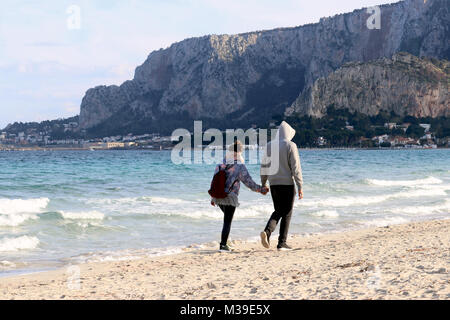 couple walking on the beach Stock Photo
