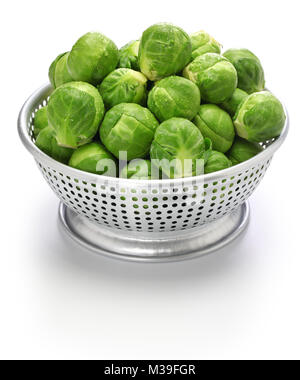 fresh brussels sprouts in colander isolated on white background Stock Photo