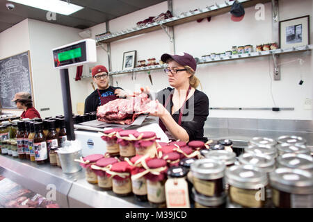 Sanagan's Meat Locker employee Katie Desormeaux works at the business' Kensington Market location in Toronto, Ontario, Canada on Friday, May 17, 2013. Stock Photo