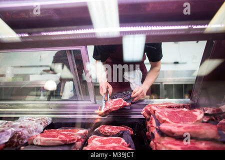 A Sanagan's Meat Locker employee works at the business' Kensington Market location in Toronto, Ontario, Canada on Friday, May 17, 2013. Stock Photo