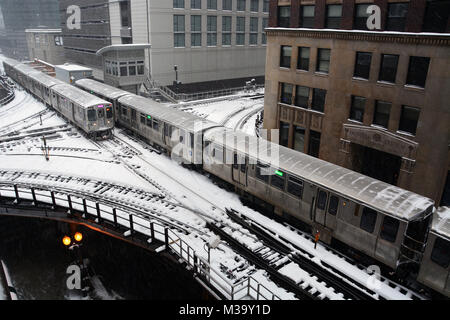 The crossing at Lake and Wells Streets where Chicago's Brown, Purple, Green, Pink, and Orange line L trains enter and exit the Loop business district Stock Photo