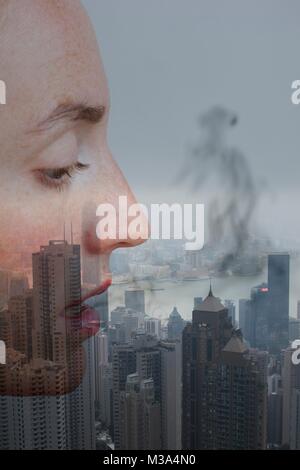 MODEL RELEASED. Conceptual image, profile of female face with smoke and city. Stock Photo