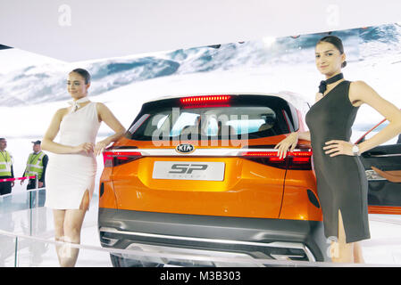Greater Noida, India. 9th February 2018. Models pose with the Kia SP Concept car on display at the Auto Expo 2018 at India Expo Mart in Greater Noida, India. The Auto Expo is a biennial event and is being held during 9th to 14th February 2018. Credit: Karunesh Johri/Alamy Live News. Stock Photo