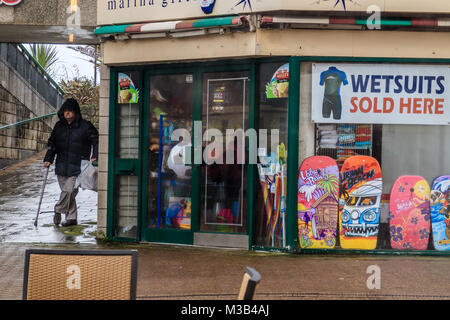 Elderly man sheltering under underpass near Torquay harbour on a wet day in February 2018. A rainy start to the half term break in Torquay, Torbay, Devon, UK.February 2018. Stock Photo