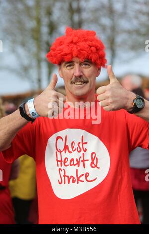 ON THE RUN AT STORMONT: 10/02/18 Hundreds of runners and walkers in red took over Stormont today to take part in Northern Ireland’s only Red Dress Run, organised by Northern Ireland Chest Heart and Stroke.  Only in its second year the event has proved hugely popular with 400 people taking part. Photo/Paul McErlane Stock Photo