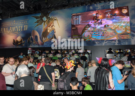 Cologne, Germany - August 24, 2017: Trade fair visitors waiting and playing the game final fantasy 14 at Gamescom 2017. Gamescom is a trade fair for v Stock Photo