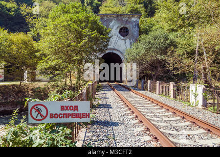 NEW ATHOS, ABKHAZIA, GEORGIA, 19 SEPTEMBER 2017: Railway tunnel in the mountain and the sign «No entrance' near the Psirtskha Railway Station Stock Photo
