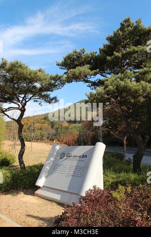 Gyeongju, South Korea - November 13, 2017: Stone carving in edict shape about The World Heritage of Yangdong Folk Village in English and korean Stock Photo