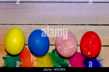colored easter eggs and nests with colored feathers Stock Photo