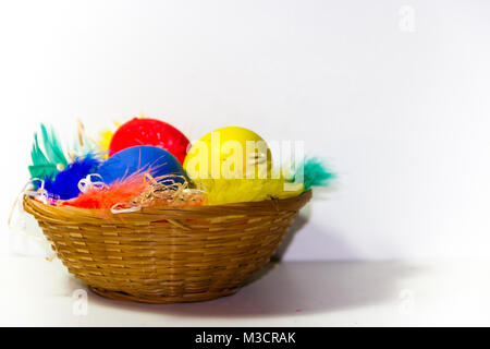 colored easter eggs and nests with colored feathers Stock Photo